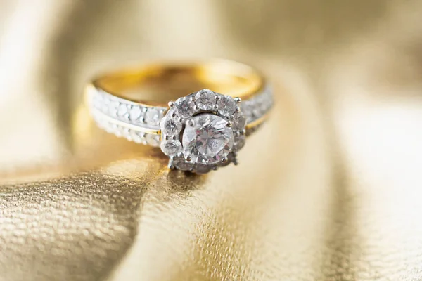 luxury jewelry diamond ring on gold background