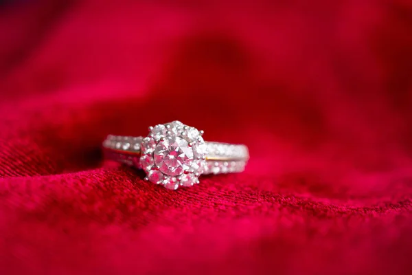 luxury jewelry diamond ring on red fabric background