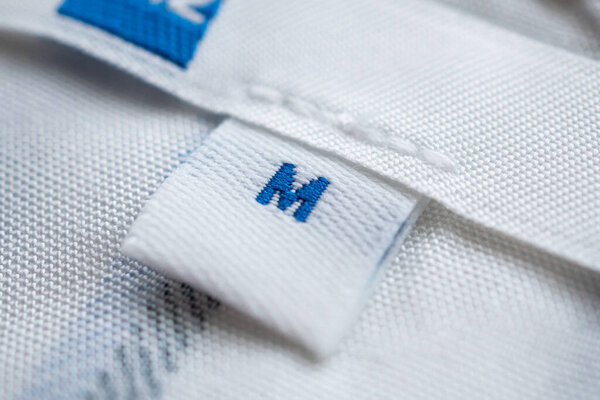 White clothes label close up on new shirt