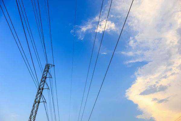 High voltage towers electric lines with clouds and sky