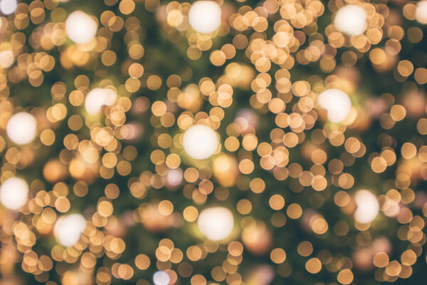 Abstract christmas holiday with festive gold bokeh light on tree blurred background