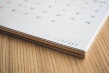 Tahta masa arkaplanındaki takvim sayfası