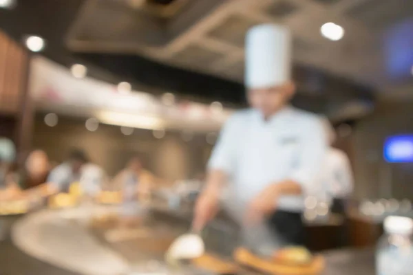 Chef cooking in restaurant kitchen abstract blurred defocused background