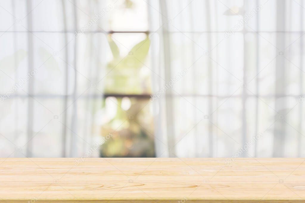 Empty wood table top with blur white curtain window and green garden background for product display template