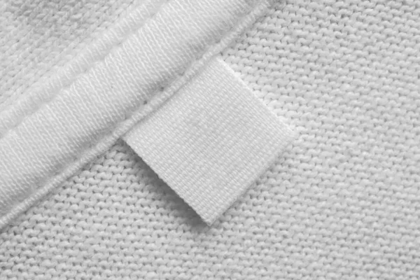 White Blank Laundry Care Clothes Label Cotton Shirt Background — Stock Photo, Image