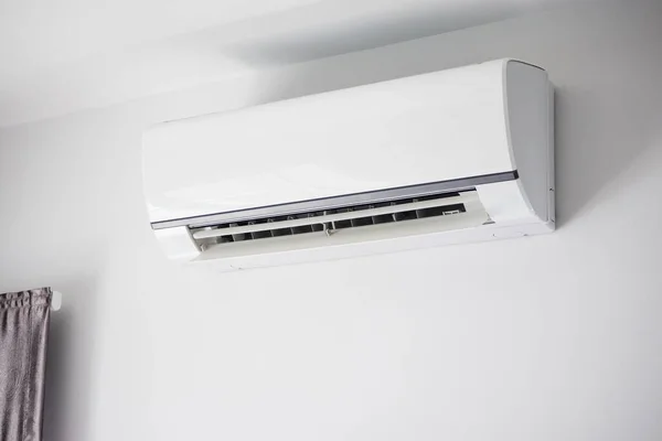 Air conditioner on white wall room interior background