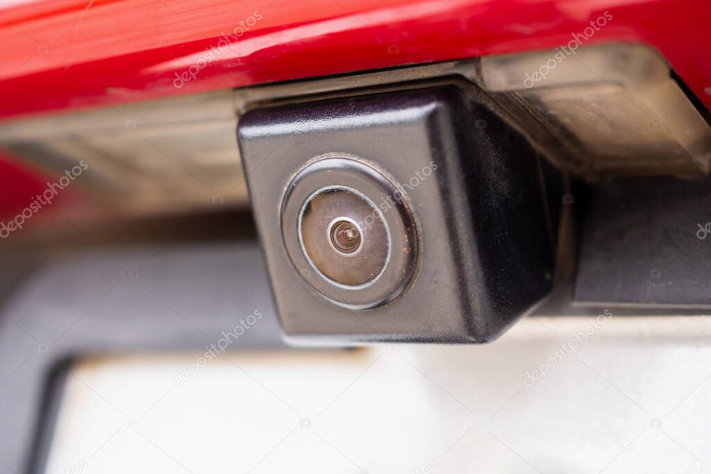 Red car rear view camera close up for parking assistance