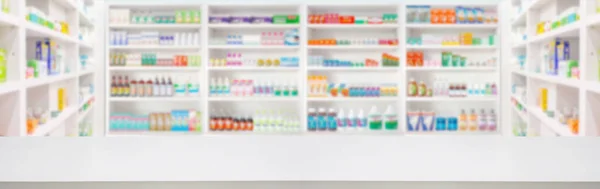 Empty wood counter top with pharmacy drugstore shelves blur pharmaceutical medicine product background