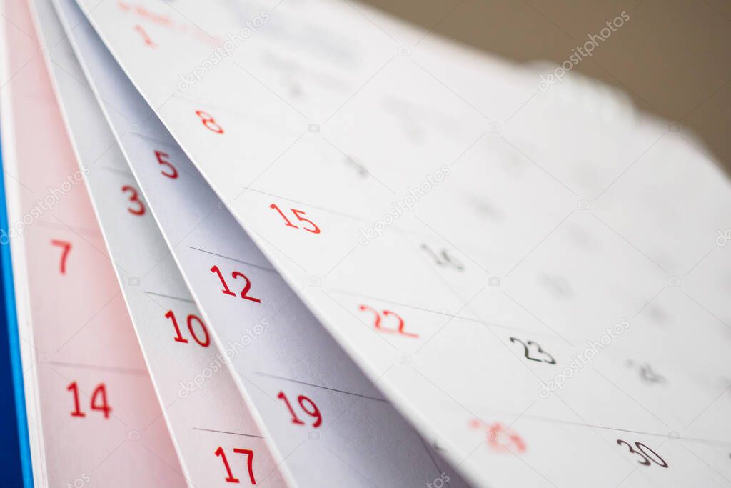 Calendar page flipping sheet close up on office table background business schedule planning appointment meeting concept