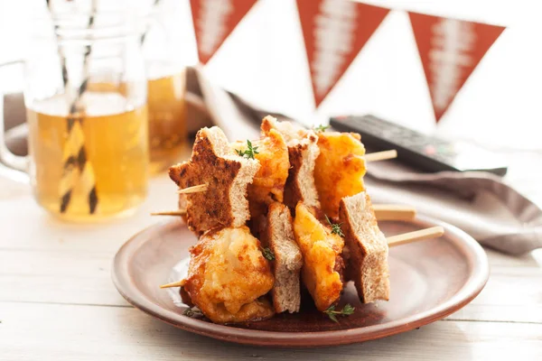 Skewers with korean fried chicken and bread in shape of stars. Snacks for superbowl party