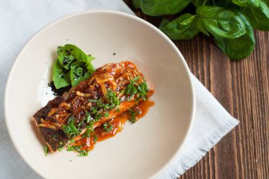 Somon fileto zencefil yağda soğan ve taze fesleğen rustik ahşap masa üzerinde sırlı