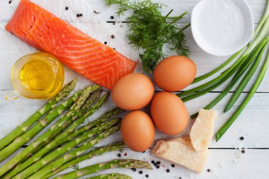 Füme alabalık, kuşkonmaz, yumurta, parmesan peyniri, yağ, krema, yeşillik. Ev yapımı frittata için malzemeler