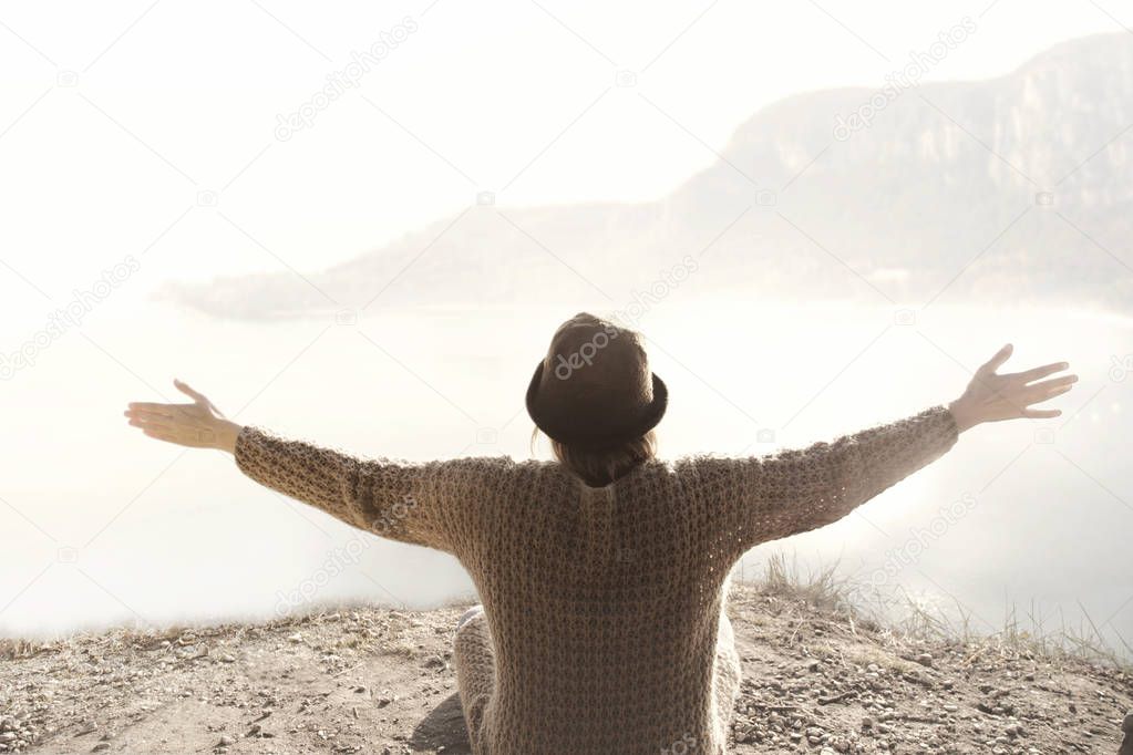 woman with open arms hugging the surrounding nature