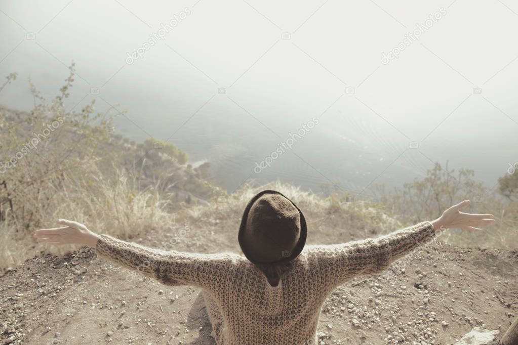 woman with open arms hugging the surrounding nature
