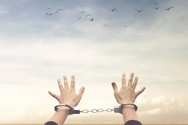 person imprisoned with handcuffs hopes in freedom