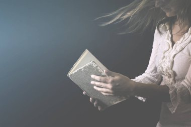 dreaming woman reads the pages of a mysterious book