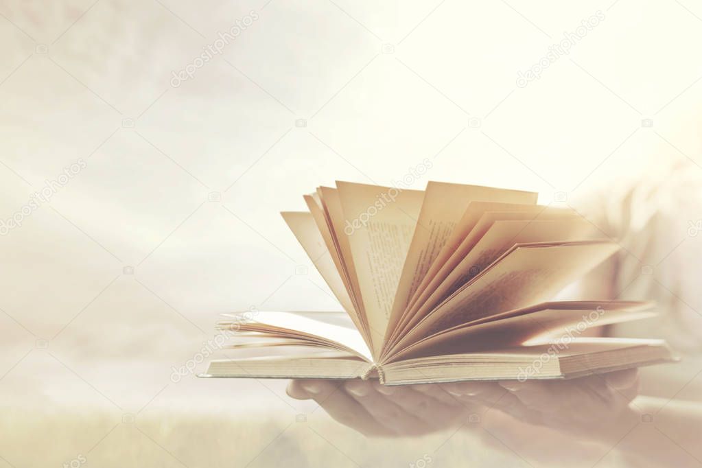 hands offering an open book, knowledge concept