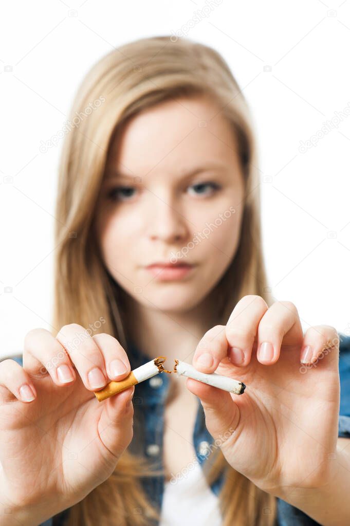 Teenage girl with cigarette isolated on white