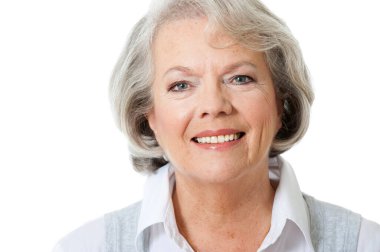 60 'lı yaşlardaki bir kadın beyaz arka planda izole edilmiş.