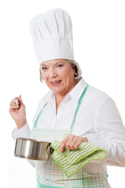 帽子とエプロン付きの高齢者料理 ロイヤリティフリーのストック画像