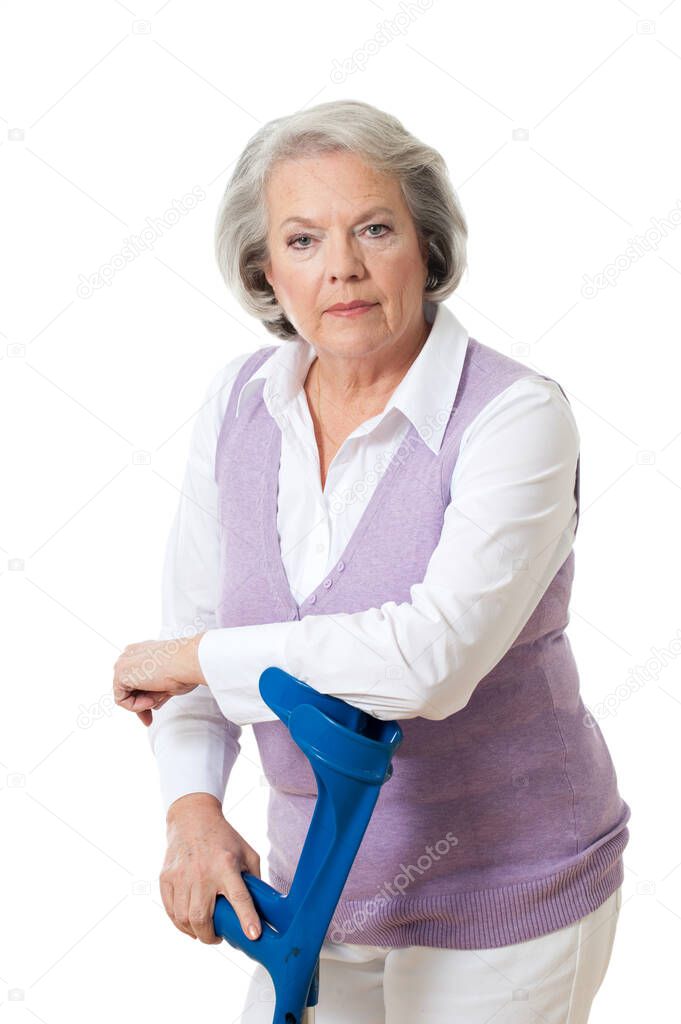 Elderly woman with crutches isolated on white