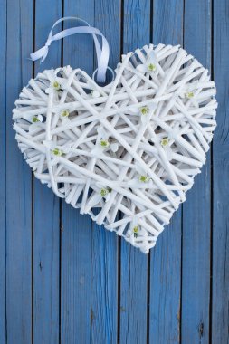 Ahşap arka planda çiçek açan bir kalp.