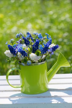 Bahçe masasında bahar çiçeği buketi