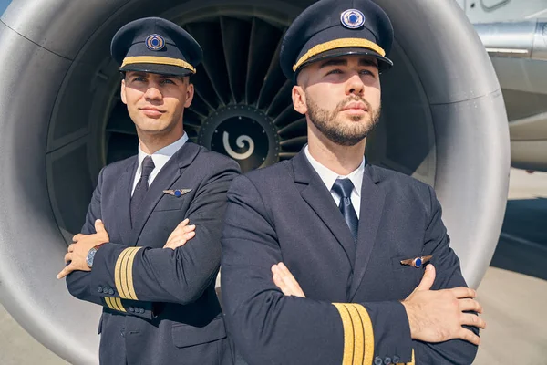 Two Caucasian airmen standing by the aircraft — Stock Photo, Image
