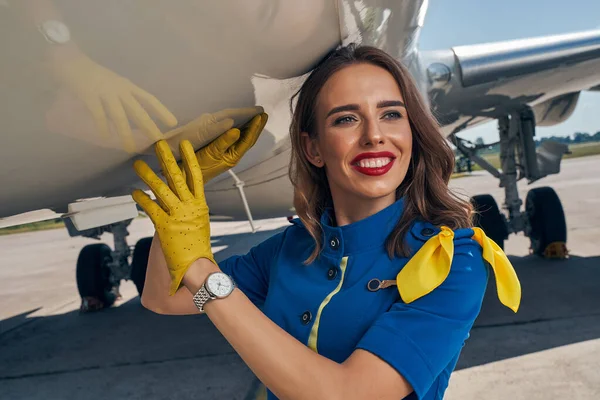 Beautiful elegant young Caucasian stewardess gazing away — Stock Photo, Image