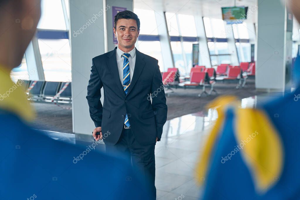 Smiling Caucasian male flight attendant looking ahead