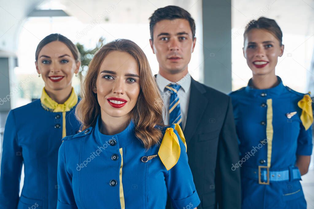 Modern cabin crew posing for the camera