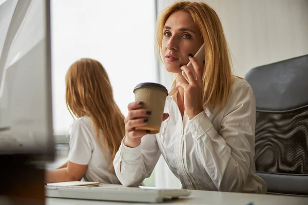 Bella donna d'affari che beve una tazza di caffè al mattino in ufficio — Foto Stock