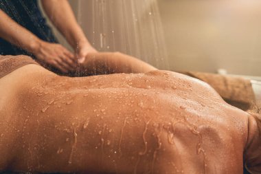 Kimliği belirsiz bir kadının ellerine masaj yapan bir masörün elleri.