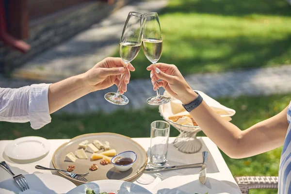 Glas met koude wijn in handen van mooi koppel — Stockfoto
