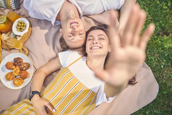 Feliz sorrindo jovem casal deitado no parque verde — Fotografia de Stock