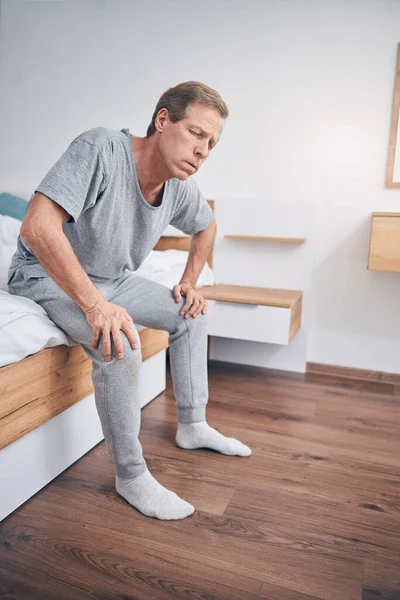 Exhausted male person trying to stand up — Stock Photo, Image