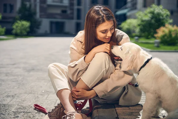 Young woman looking fondly at her pet — Stock Photo, Image