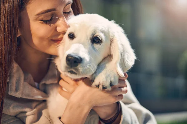 Szczęśliwa ładna pani przytula swojego zwierzaka na zewnątrz — Zdjęcie stockowe