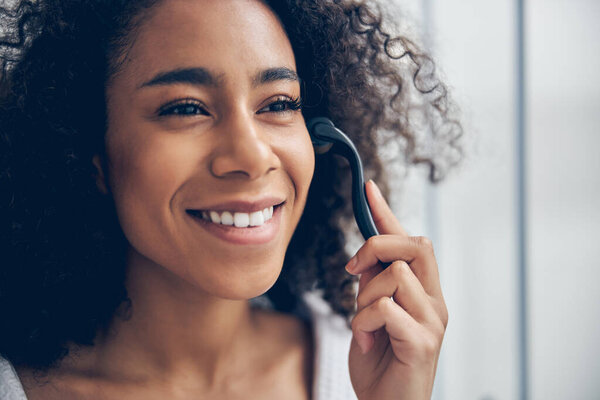 Женщина с массажным инструментом смотрит вдаль