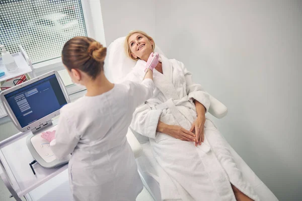 Cheerful patient doing checkup of her thyroid gland — Stock Photo, Image