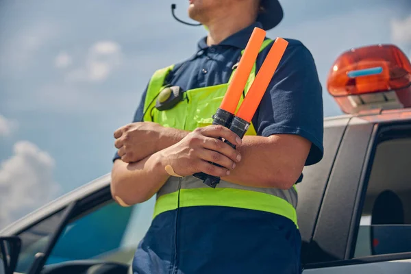 Man holding marshalling wands in one hand — Stock Photo, Image