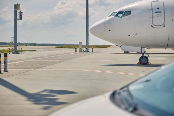 Civil aircraft and a motor car parked at the airdrome