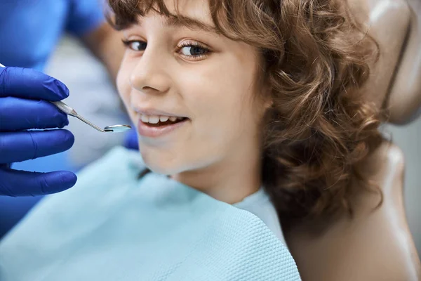 Positive-looking child smiling in a dentists office — Stock Photo, Image
