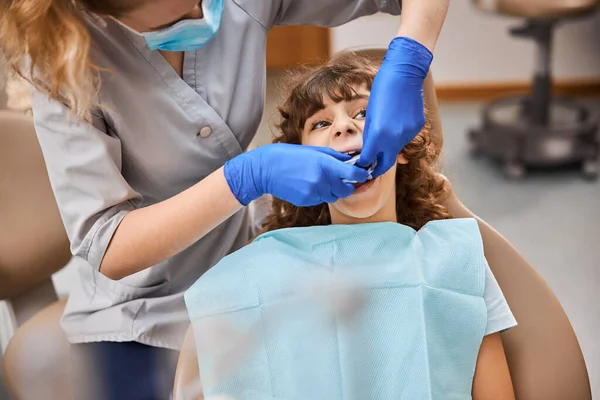 Cute boy sitting nicely during a dental procedure — Stock Photo, Image