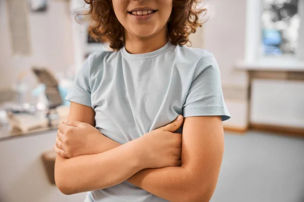 Gladsome child smiling and having his arms crossed — Stock Photo, Image