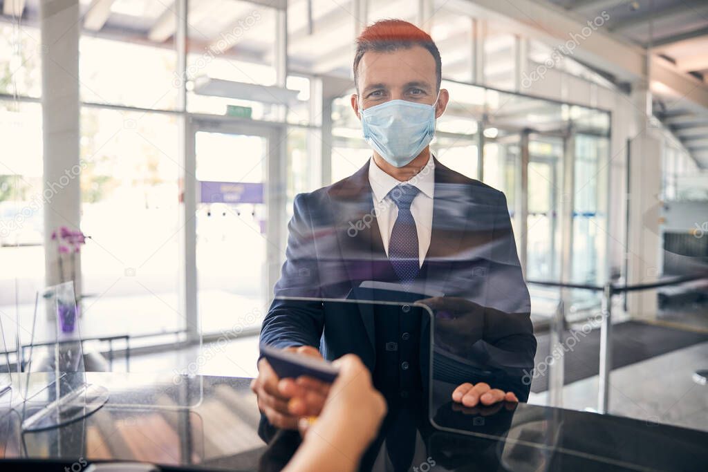 Diligent traveler wearing a mask at a flight check-in