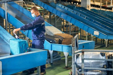 Torba görevlisi bir çantanın etiketini kontrol ediyor.