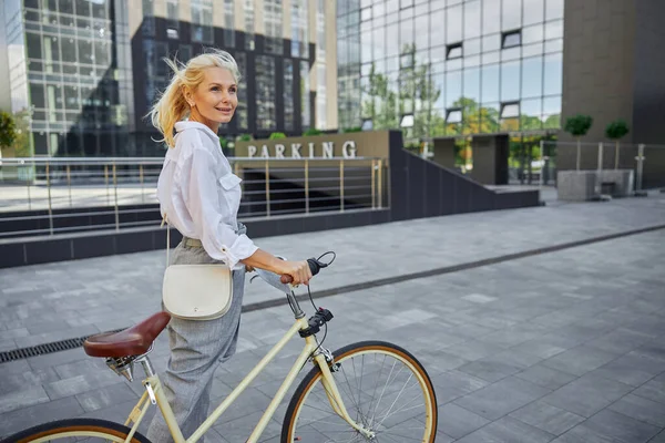 欧洲快乐的女性，在空荡荡的城市里骑着现代自行车 — 图库照片