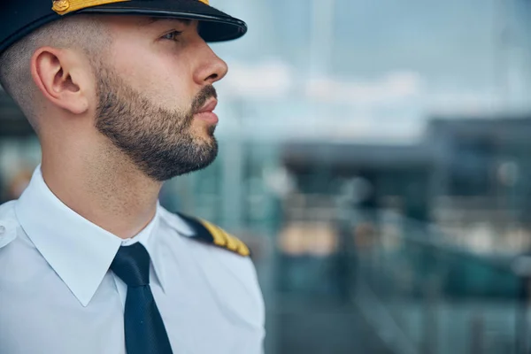 Handsome male pilot in captain hat standing on the street — Stock Photo, Image