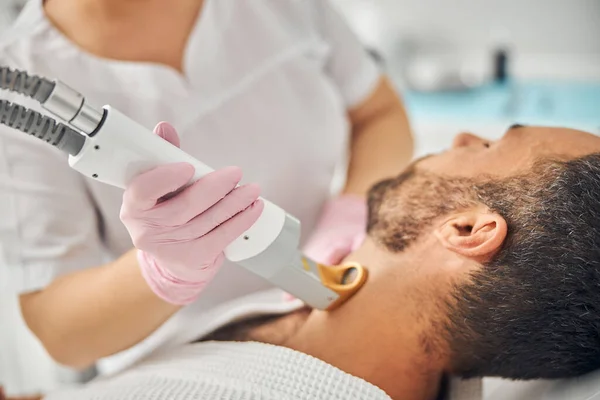 Unshaven young man having laser hair removal procedure — Stock Photo, Image